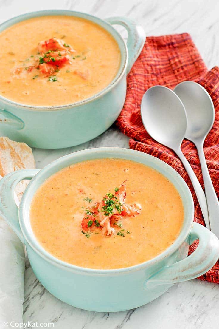 two bowls filled with soup on top of a table