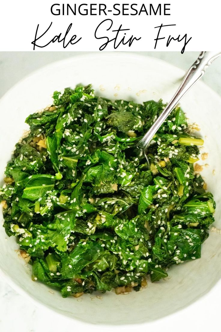 a white bowl filled with greens and sesame seeds