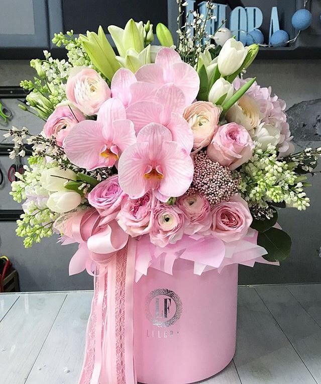 a pink box with flowers in it on a table