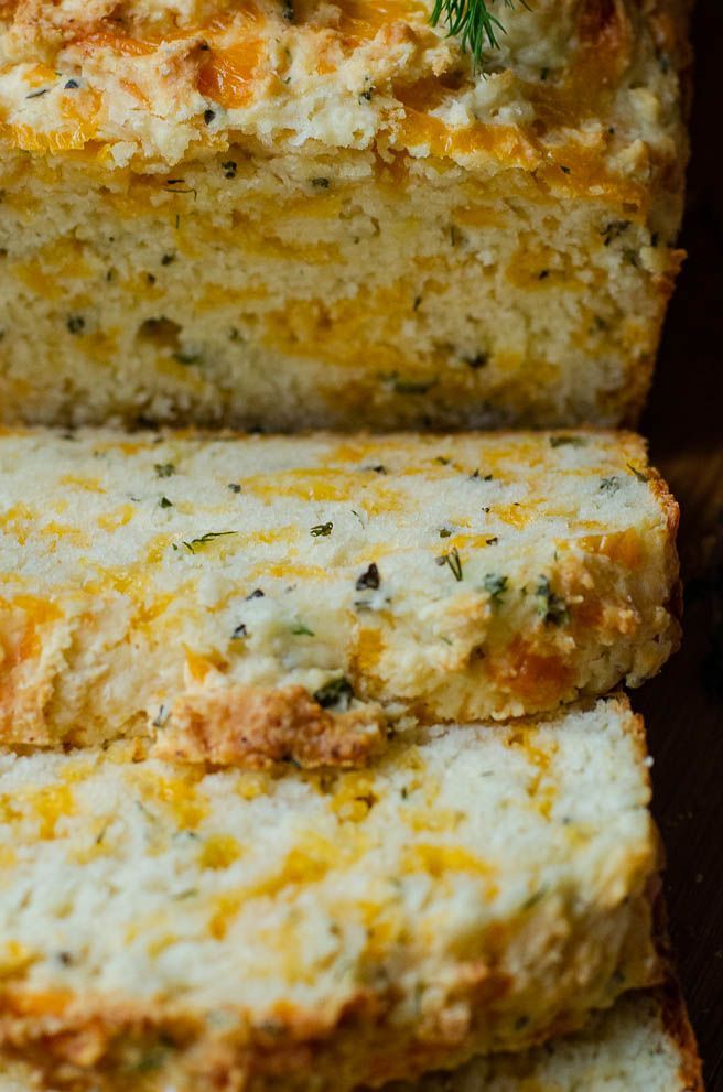 slices of bread with cheese and herbs on top