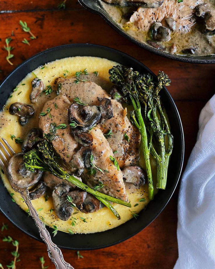 a plate of food with mushrooms and broccoli next to a skillet filled with mashed potatoes