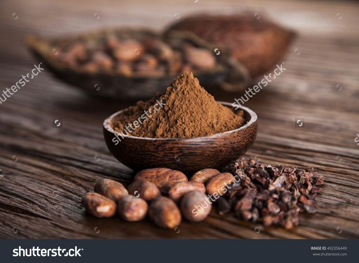 nuts and powdered cocoa on wooden table with spoons stock photo edit to see more images