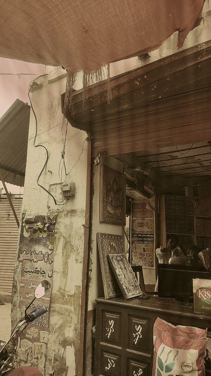 an old building with lots of graffiti on the wall and furniture in front of it