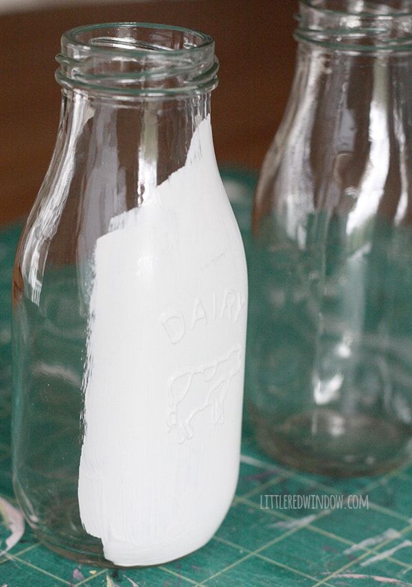 there are three glass jars with white stuff in them on the tableclothed surface