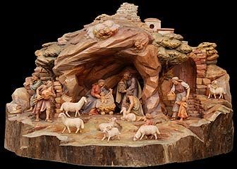 a nativity scene with figurines and animals on a rock formation in front of a black background