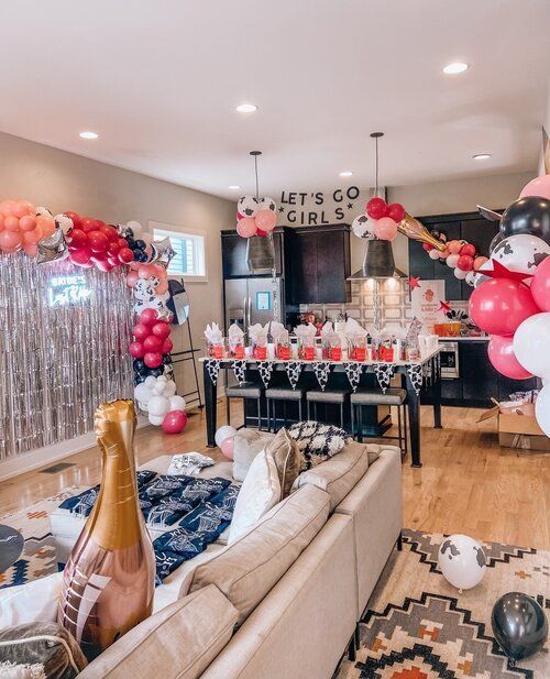 a living room filled with furniture and balloons