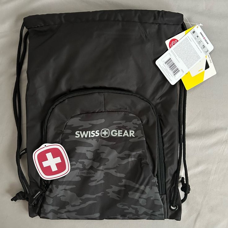 a swiss gear bag with its contents laid out on the bed