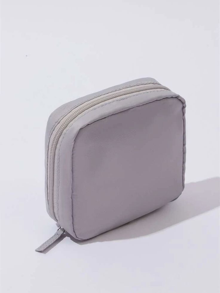 a small gray purse sitting on top of a white table