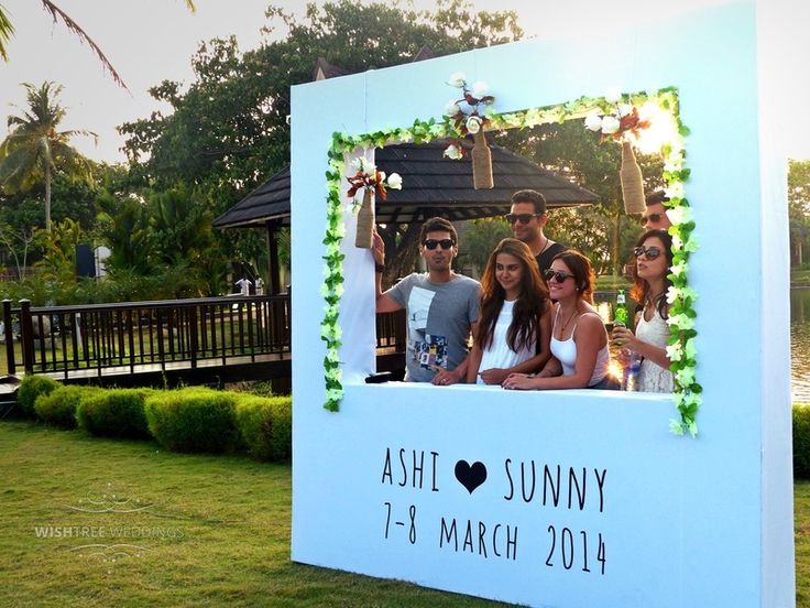 a group of people standing in front of a photo frame with the words ashi sunnyy on it