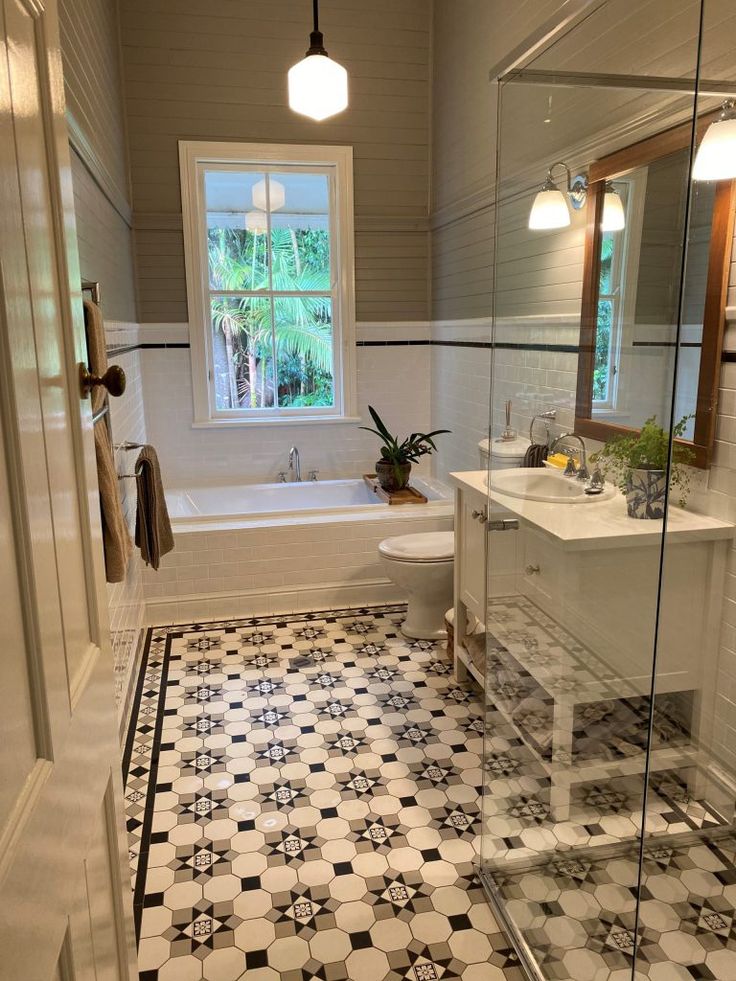 a bathroom with black and white tile flooring