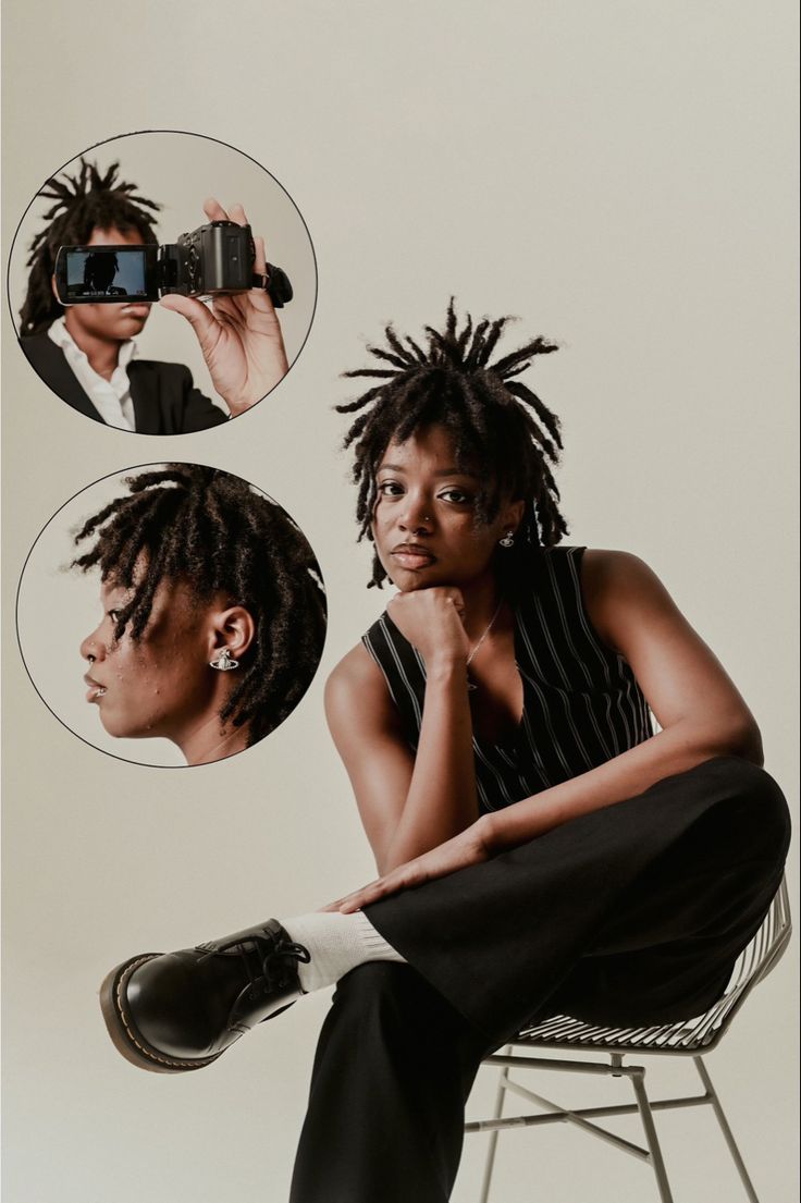 a woman with dreadlocks sitting on a chair and taking a selfie in the mirror