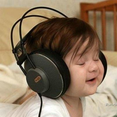 a young child wearing headphones while laying in bed