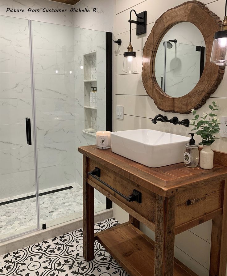 a bathroom with a sink, mirror and shower stall in it's own area