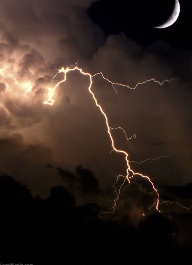 the moon is in the cloudy sky with lightning