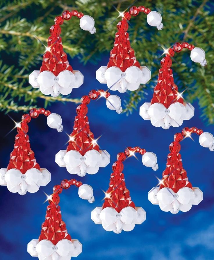 christmas decorations made out of cotton balls and candy canes hanging from a tree branch