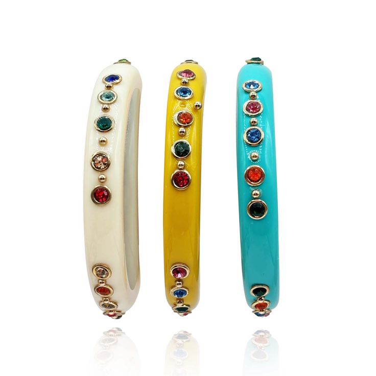 Discover elegance with our essential Turquoise Resin Bangle Set, adorned with vibrant multi-color crystals and small brass balls—a perfect choice for enthusiasts of elaborate bracelets. Crafted for sophistication, this bangle set features turquoise resin complemented by a stunning array of multi-color crystals and delicate brass balls. Its versatile design allows it to shine beautifully on its own or as part of a layered bangle ensemble. Whether you're seeking a statement piece for a special occasion or enhancing your everyday attire, these bangles add a touch of charm and versatility to any outfit. Avoid contact with water and cosmetics, such as creams or perfumes. Clean with a clean dry cloth. Comes with velvet pouch Turquoise Resin, Resin Bangles, June Birthstone Jewelry, Gifts For New Mums, Pearl Jewellery Earrings, Velvet Pouch, Jewelry Ring Box, Bangle Set, Men's Jewelry Rings