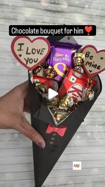 someone is holding up a box with chocolates in it and the words i love you written on them