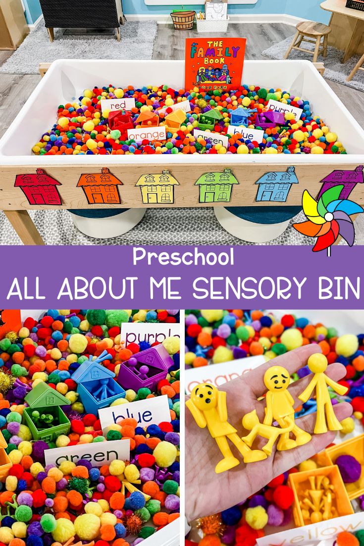 a child's hand holding a toy in front of a pile of colorful toys