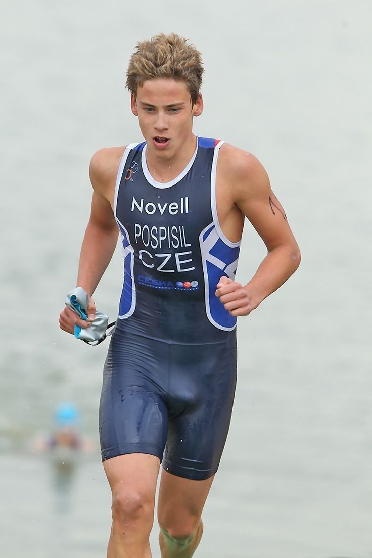 a man running on the beach in his wet suit