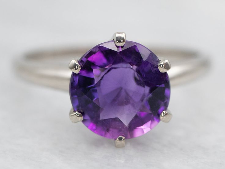 This ring is designed with luxurious white gold and a genuine amethyst stone. Its timeless single-stone design adds a sophisticated touch to any outfit, making it perfect for a special occasion.Metal: 14K White GoldGem: Amethyst 1.71 CaratsGem Measurements: 8.5 mm, RoundRing Size: 7.50Marks: "14K" Stamped on the inside band Classic Amethyst Solitaire Ring, Classic White Gold Amethyst Ring, Elegant White Gold Amethyst Ring With Polished Finish, Classic White Gold Amethyst Ring With Polished Finish, White Gold Amethyst Ring, Round Cut, Pocket Watch Chain, Single Stone, Watch Chain, Stone Design