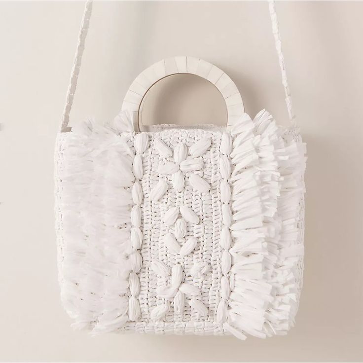 Brand New With Tags! Sold Out Online. Cleobella - From Anthropologie Beach-Ready And Oh-So-Chic, This Raffia Tote Features Abundant Texture Courtesy Of Fringe And Woven Florals. A Wood-Inlay Top Handle And A A Shoulder Strap Complete The Look. Part Of A Special Collection From Bhldn. For The Full Assortment, Visit Bhldn.Com. Loop Closure 8"H; 12"W; 3"D 16" Strap Drop Raffia, Canvas, Wood Imported Summer White Top Handle Shoulder Bag, White Top Handle Shoulder Bag For Summer, Chic White Woven Straw Bag, Chic White Straw Bag With Braided Handles, White Top Handle Crochet Bag For Shopping, White Top Handle Shoulder Bag For Vacation, White Top Handle Summer Bag, White Top Handle Beach Bag For Summer, White Woven Top Handle Bag