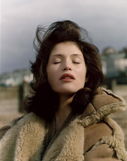 a woman with her eyes closed wearing a fur coat