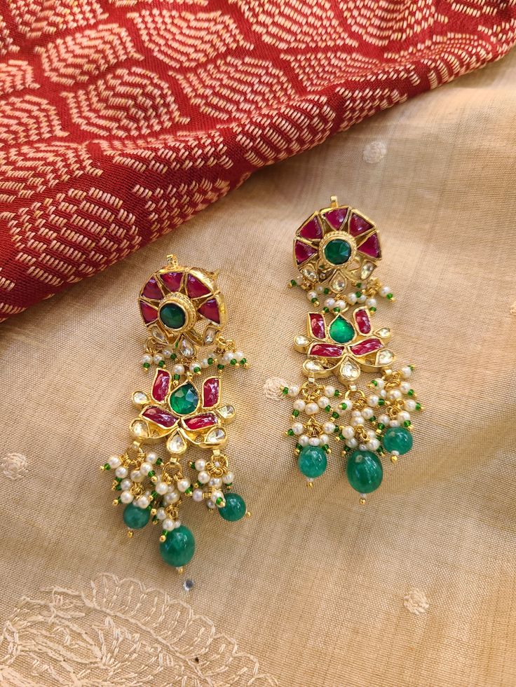 Pure Ahmedabadi pach kundan earrings crafted to perfection! A refined jewelry engraved with precious pachi kundan stones! Each piece has an intricate bead work to enrich its elegance. Size: 2.5 inches Occasion: festival or wedding or casual Metal : copper Stones: pachi kundan Handmade Made in india Care: wipe ur jewelry with soft cloth after each use and store in a airtight plastic bag! Don't soak in water Chandbali Jhumkas With Dori Work For Festivals, Festival Chandbali Dori Work Jhumkas, Diwali Chandbali Jhumkas With Dori Work, Festive Kundan Jhumkas With Dori Work, Kundan Meenakari Earrings In Temple Jewelry Style, Bollywood Kundan Jhumkas With Dori Work, Festive Chandbali Jhumkas With Dori Work, Kundan Meenakari Chandbali Pearl Earrings, Festive Kundan Meenakari Danglers