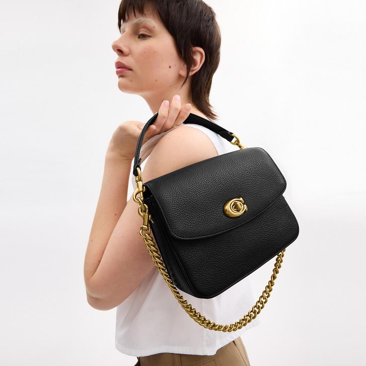 A more compact Cassie our 19 is smaller than the original and made for days or nights on the go. The polished pebble leather design is finished with a Signature turnlock closure and three interchangeable straps for versatile styling. Detach the crossbody strap and carry by hand with the leather and chain top handles together or separately. | Coach Cassie Crossbody Bag 19 - Women's Designer Crossbody - Brass/black Coach Pebbled Leather Bag With Adjustable Strap, Coach Pebbled Leather Shoulder Bag With Detachable Strap, Coach Bags With Metal Hardware For Work, Coach Pebbled Leather Satchel With Detachable Strap, Timeless Coach Bag With Detachable Strap, Versatile Coach Shoulder Bag With Gold-tone Hardware, Versatile Coach Satchel With Detachable Strap, Coach Flap Bag With Adjustable Strap For Everyday Use, Versatile Coach Bag With Gold-tone Hardware