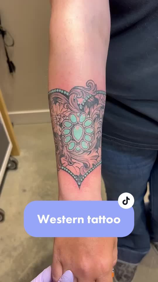 a person with a tattoo on their arm and the words western tattoo written below it