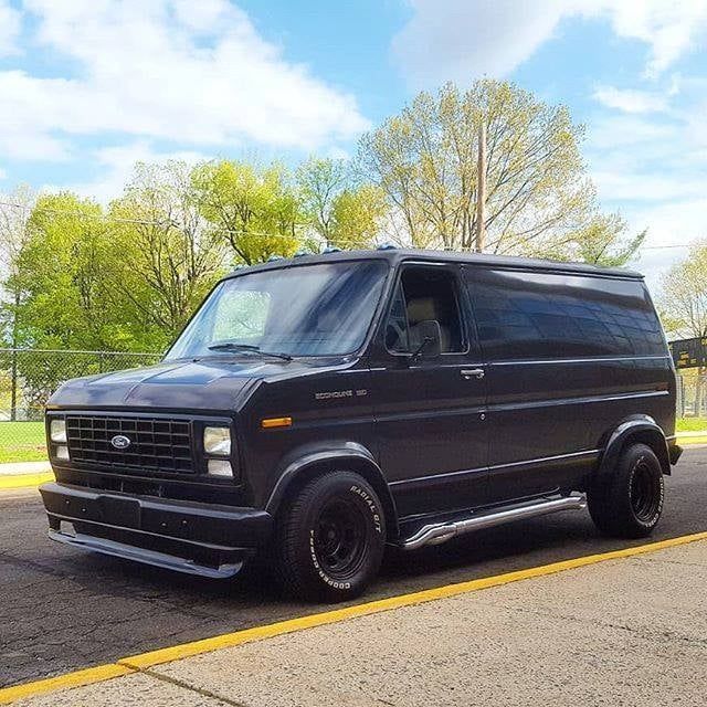 a black van is parked in a parking lot