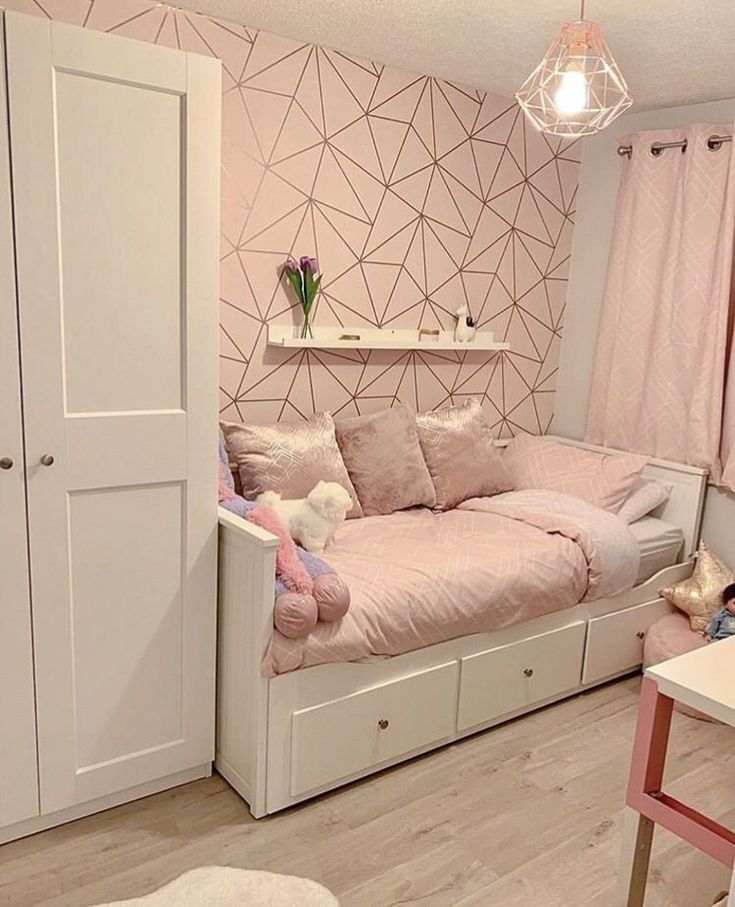 an instagram photo of a bedroom with pink and white decor, including a bed