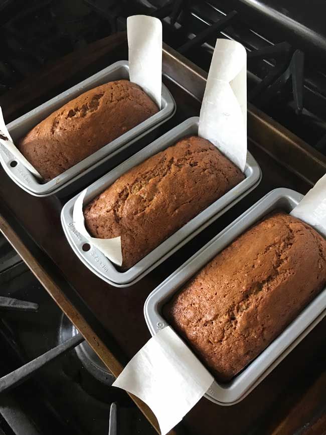 three loafs of bread sitting on top of an oven