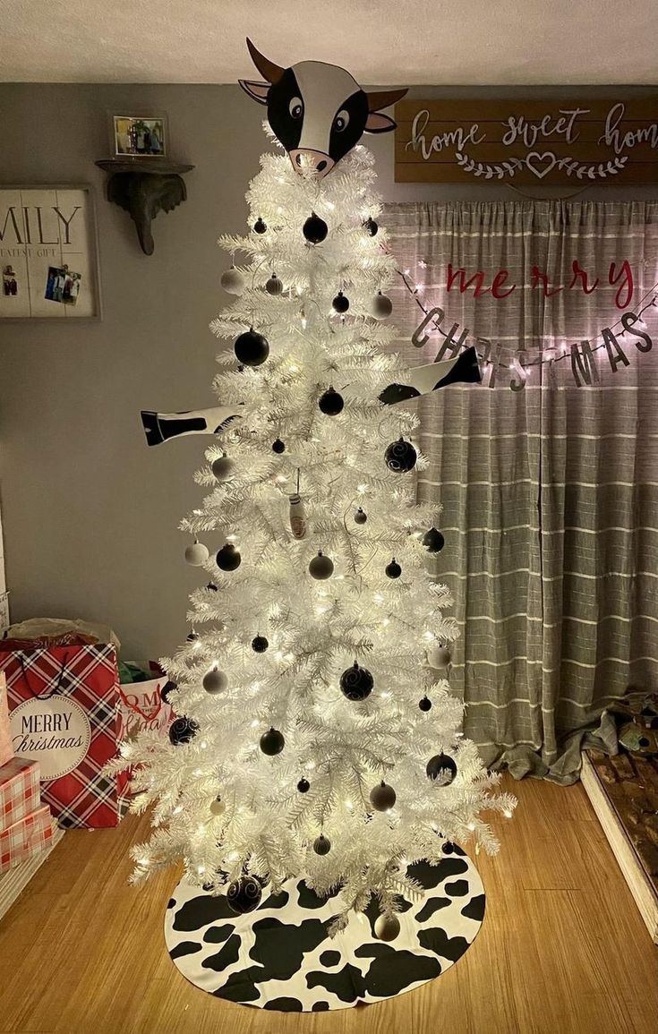 a white christmas tree decorated with black and white ornaments