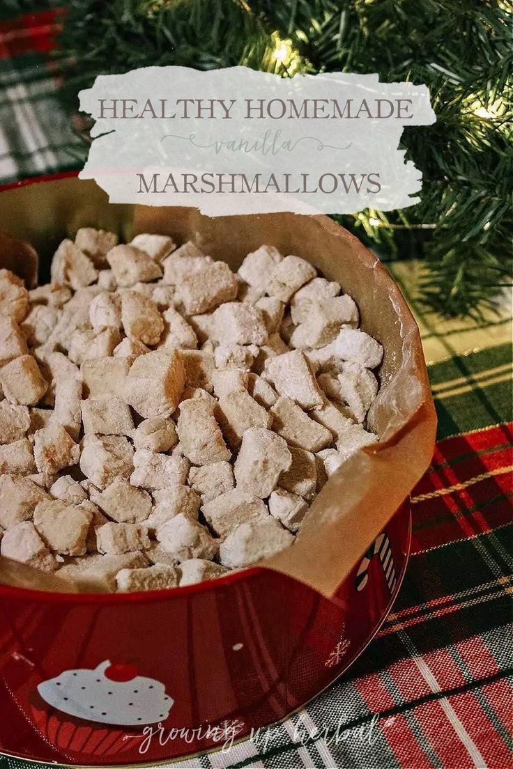 a red bowl filled with marshmallows on top of a table