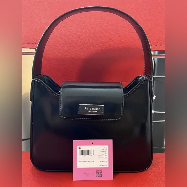 Kate Spade New York Handbag K8819blk Designer Black Baguette Bag For Travel, Designer Black Baguette Crossbody Bag, Shopping Satchel Baguette Bag With Branded Hardware, Black Designer Satchel Baguette Bag, Designer Black Baguette Bag With Detachable Strap, Designer Black Baguette Bag For Daily Use, Black Luxury Satchel Baguette Bag, Luxury Black Satchel Baguette Bag, Rectangular Baguette Bag With Branded Hardware For Shopping