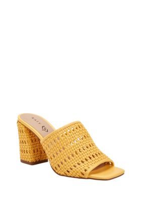 a woman's yellow mules with an open toe and woven fabric on the heel