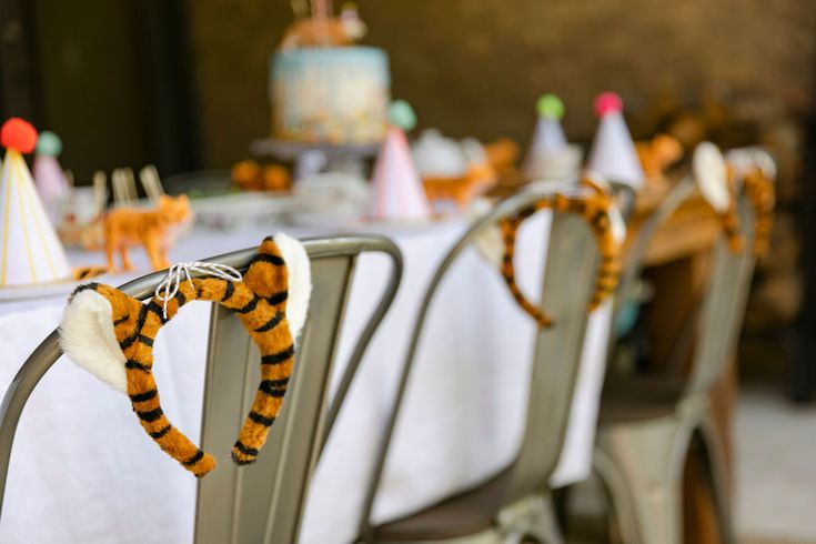 the table is set for a birthday party with winnie the pooh decorations on it