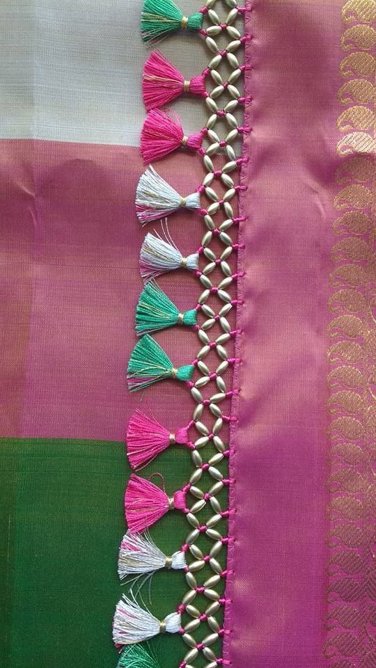 pink and green saree with tassels on it