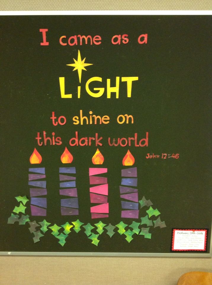 a bulletin board with candles on it that says, i came as a light to shine on this dark world