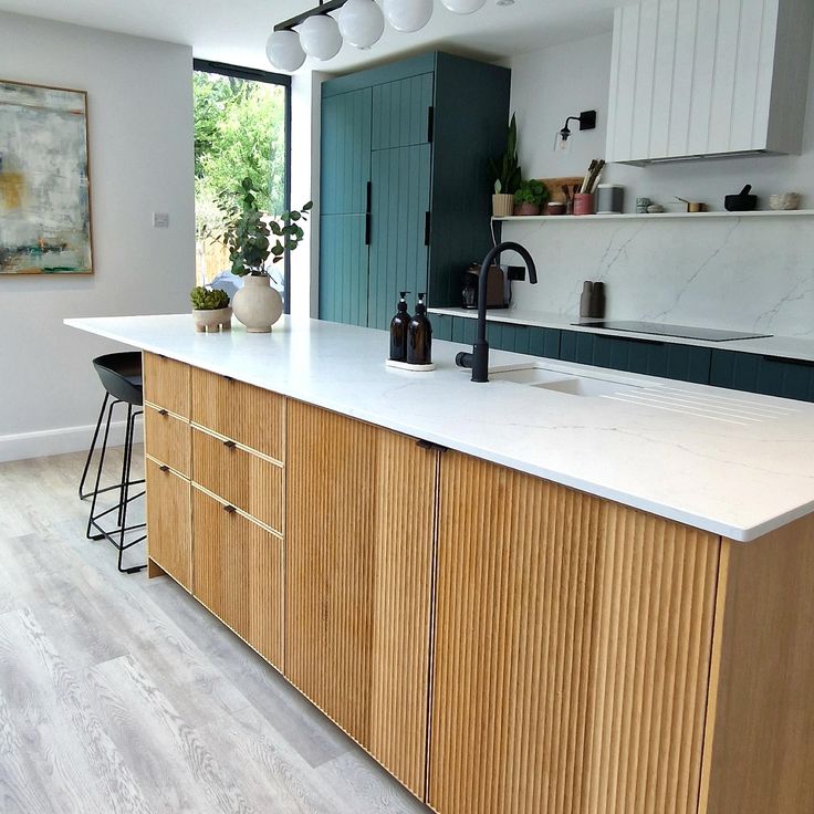 a kitchen with an island counter and wooden cabinets