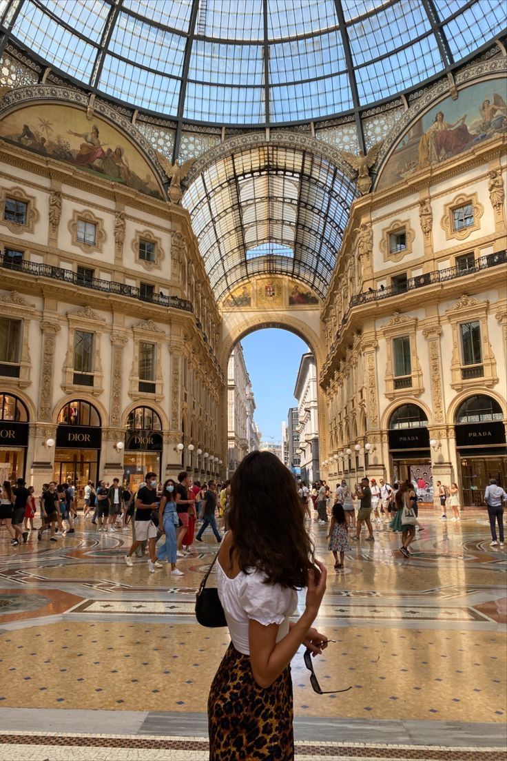 a woman standing in the middle of a shopping mall