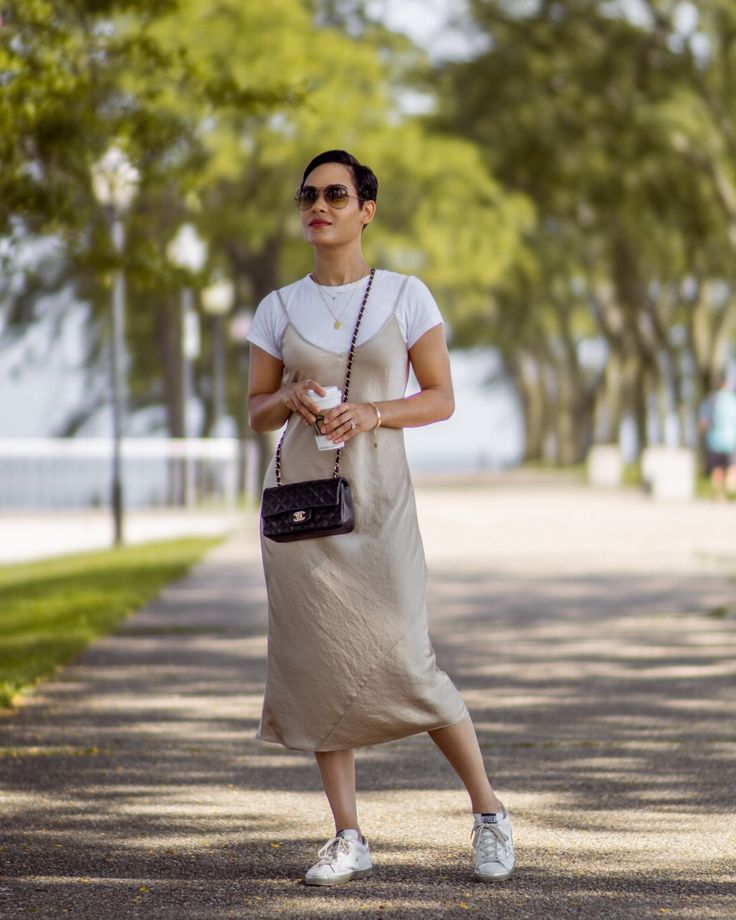 Slip Dress With Sneakers, Slip Dress Outfit Fall, Dress With Shirt Underneath, Slip Dress Street Style, Grace Byers, Gold Slip Dress, Silk Dresses Outfit, Dress And Sneakers Outfit, Slip Dress Outfit