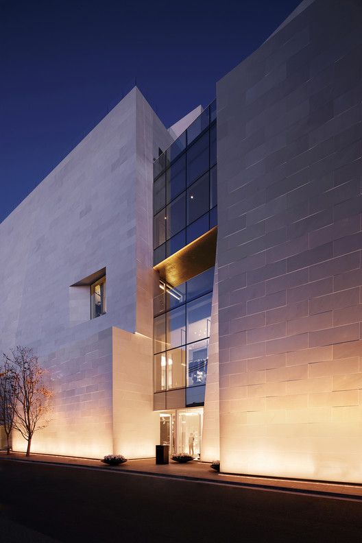 a large white building with windows lit up at night