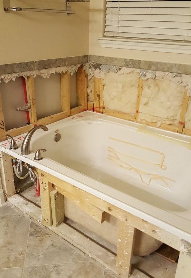 a bathtub being built in a bathroom under construction