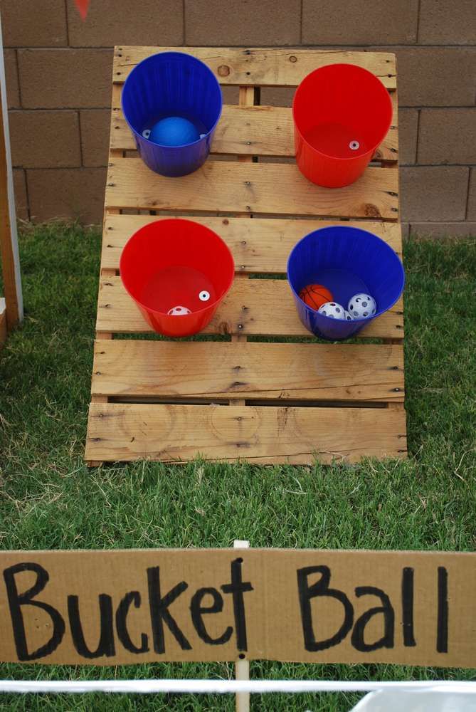 buckets and bowls are on display in front of a sign that says bucket ball