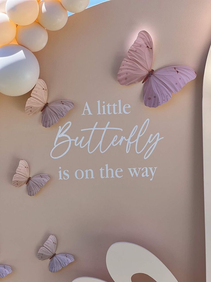 there are many butterflies on the wall and one is saying a little butterfly is on the way