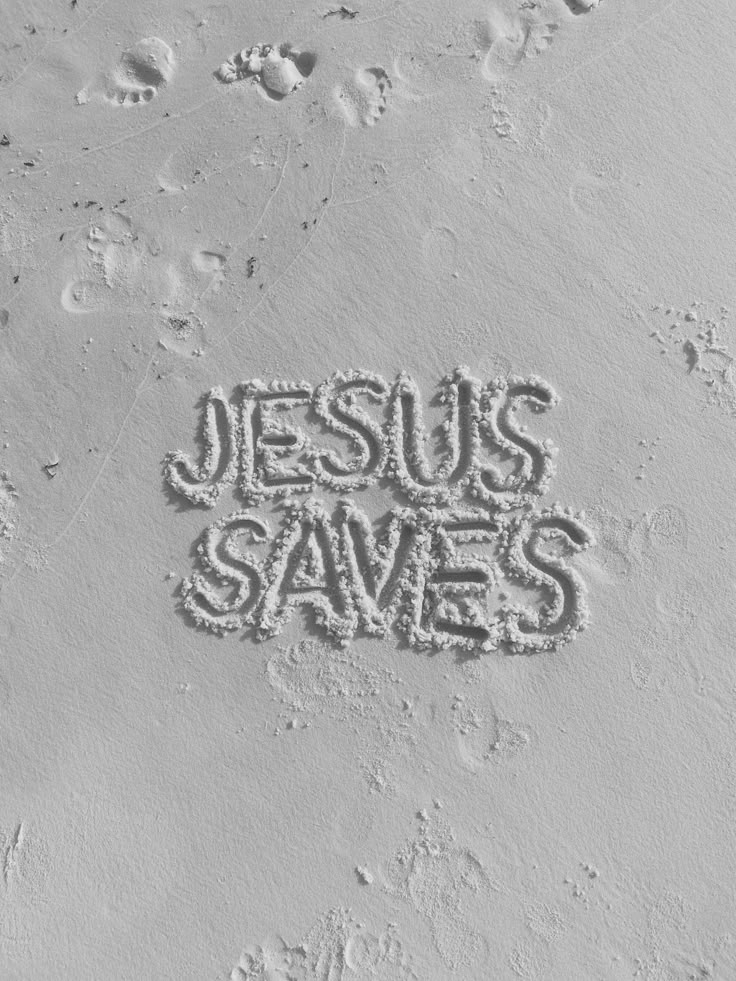 the word jesus saves written in sand