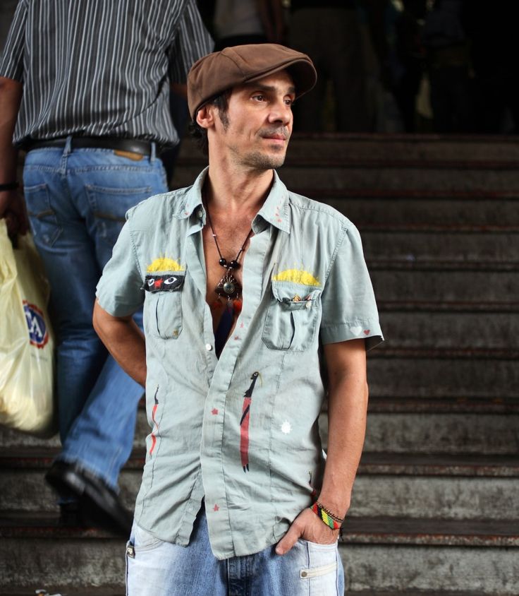 a man standing in front of some steps with his hands on his hips and looking at the camera