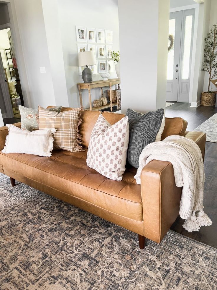 a living room filled with furniture and pillows