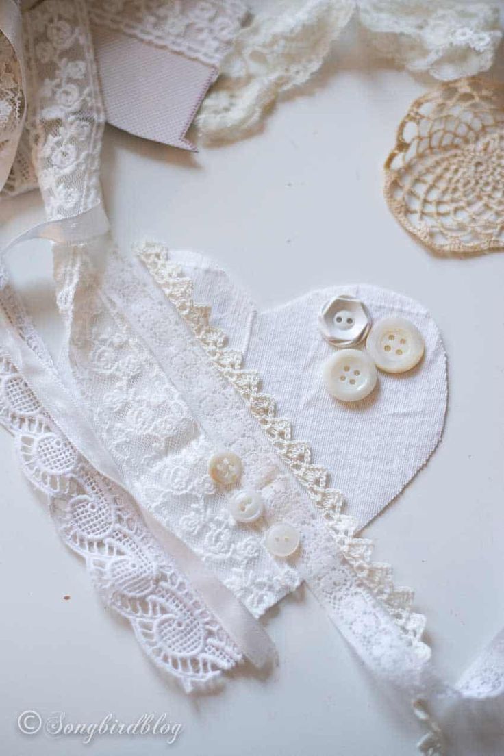 some white lace and buttons on a table